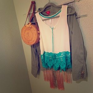 Sleeveless tank with green lace detail.